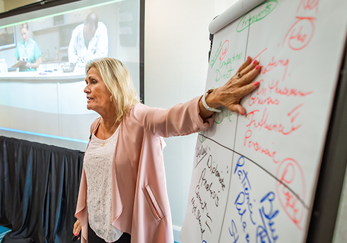 Leadership Academy teacher at a whiteboard