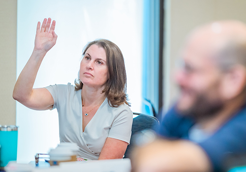 Leadership Academy participant with her hand raised