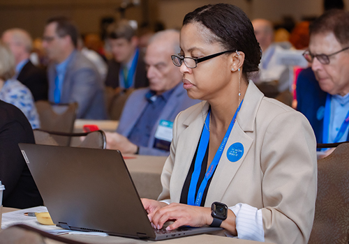 Women sits at desk on her computer