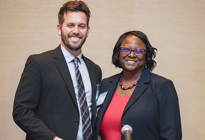 John Dahl poses with Dr. Littles to accept his award.