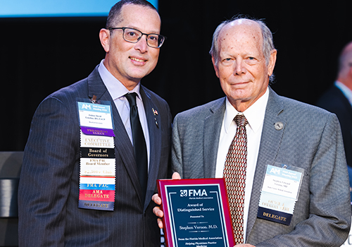 Dr. Lenchus presents an award to Dr. Vernon