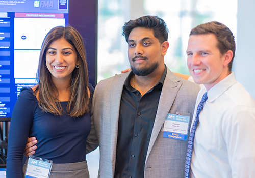 A group of students pose for a photo during the FMA Poster Symposium