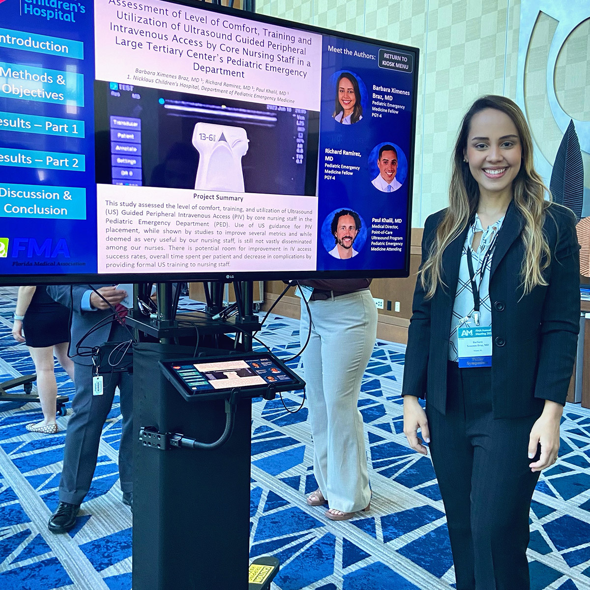 Barbara Ximenes Braz, MD stands with her winning poster