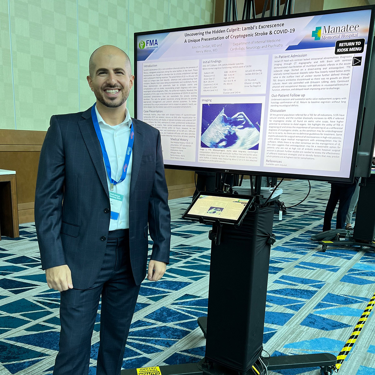 Amir Zeidan, MD stands with his winning poster. 