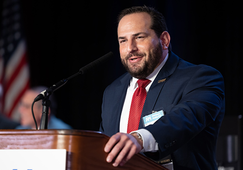 Dr. Goldman speaking at a podium 