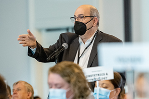Man speaking at a microphone