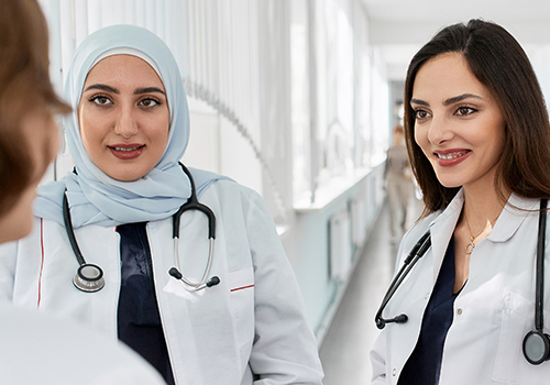 Two female medical students stand next to each other