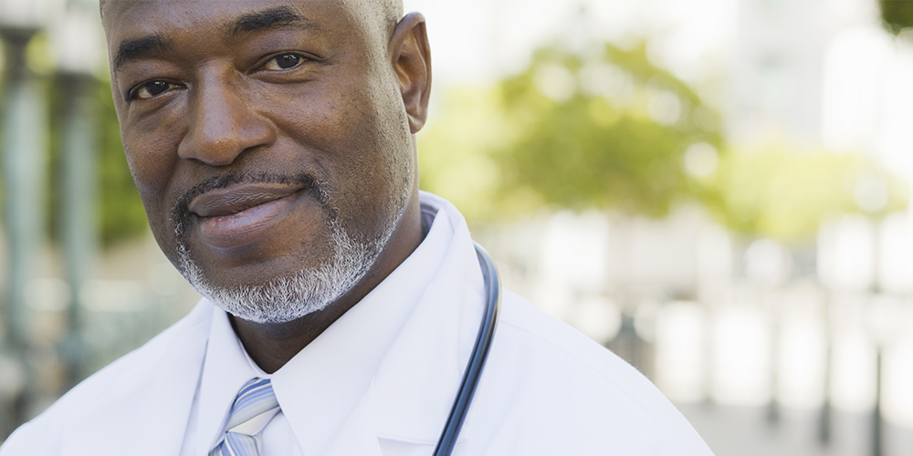 Black male physician smiling at the camera