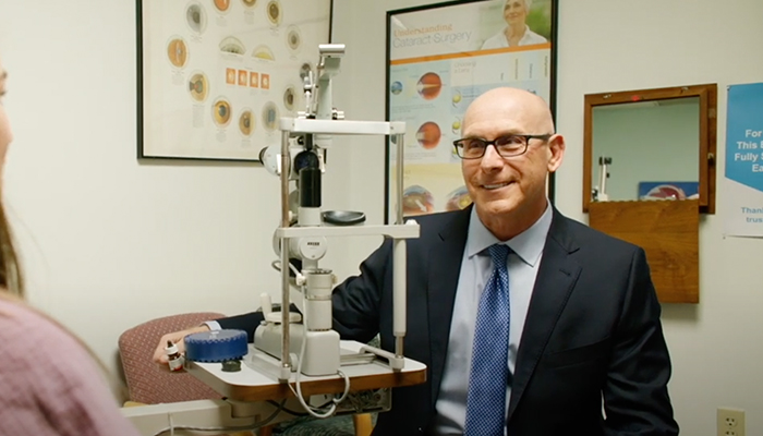 Robert Friedman, MD, talks with a patient in his office