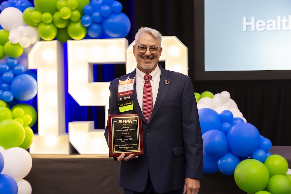 Dr. Corey Howard receiving the 2024 Award of Distinguished Service